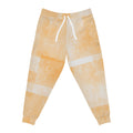 Peach tie-dye joggers with elastic waist, white drawstring, and patchwork stripe panels