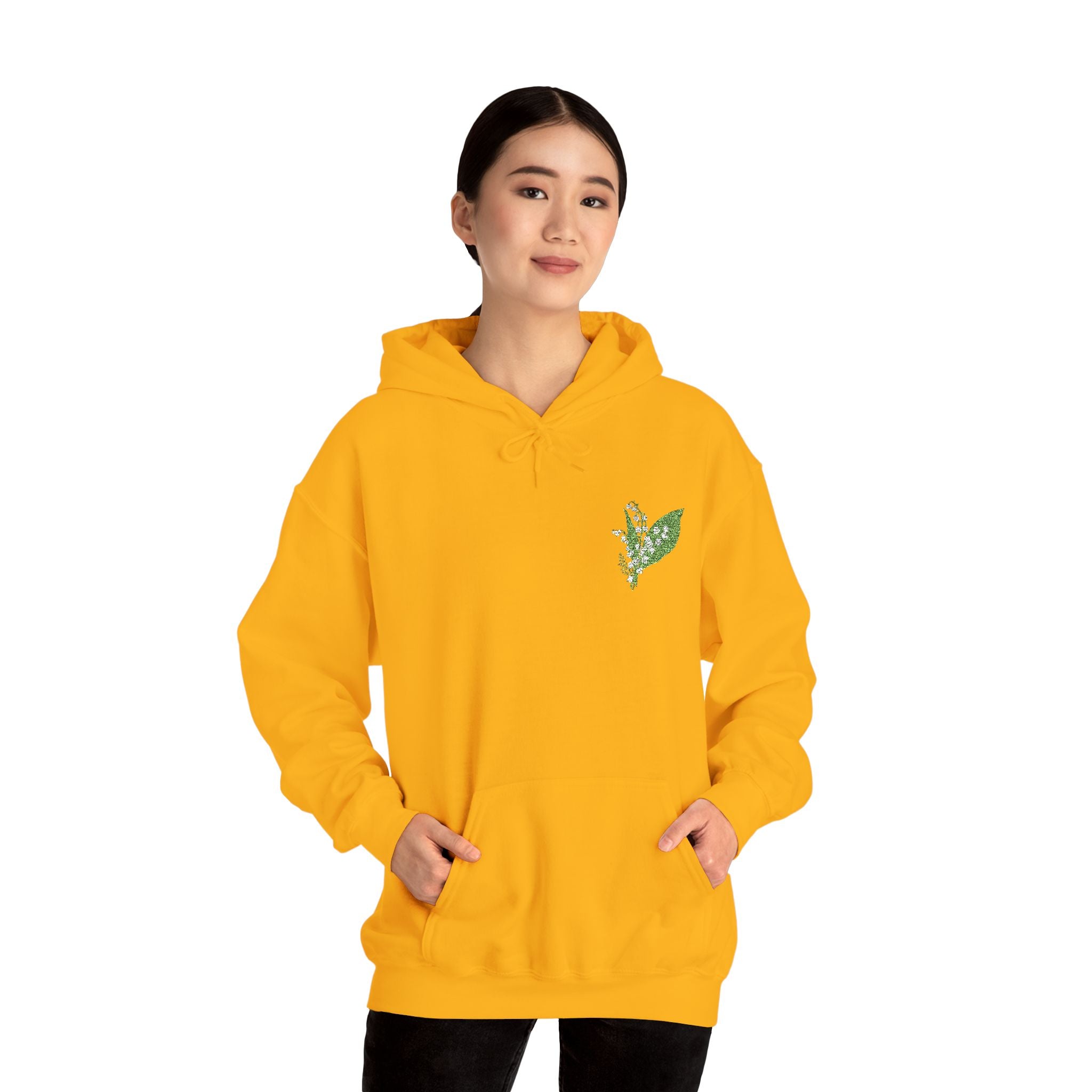 Gold hoodie with green leaf embroidery on chest and hood drawstrings