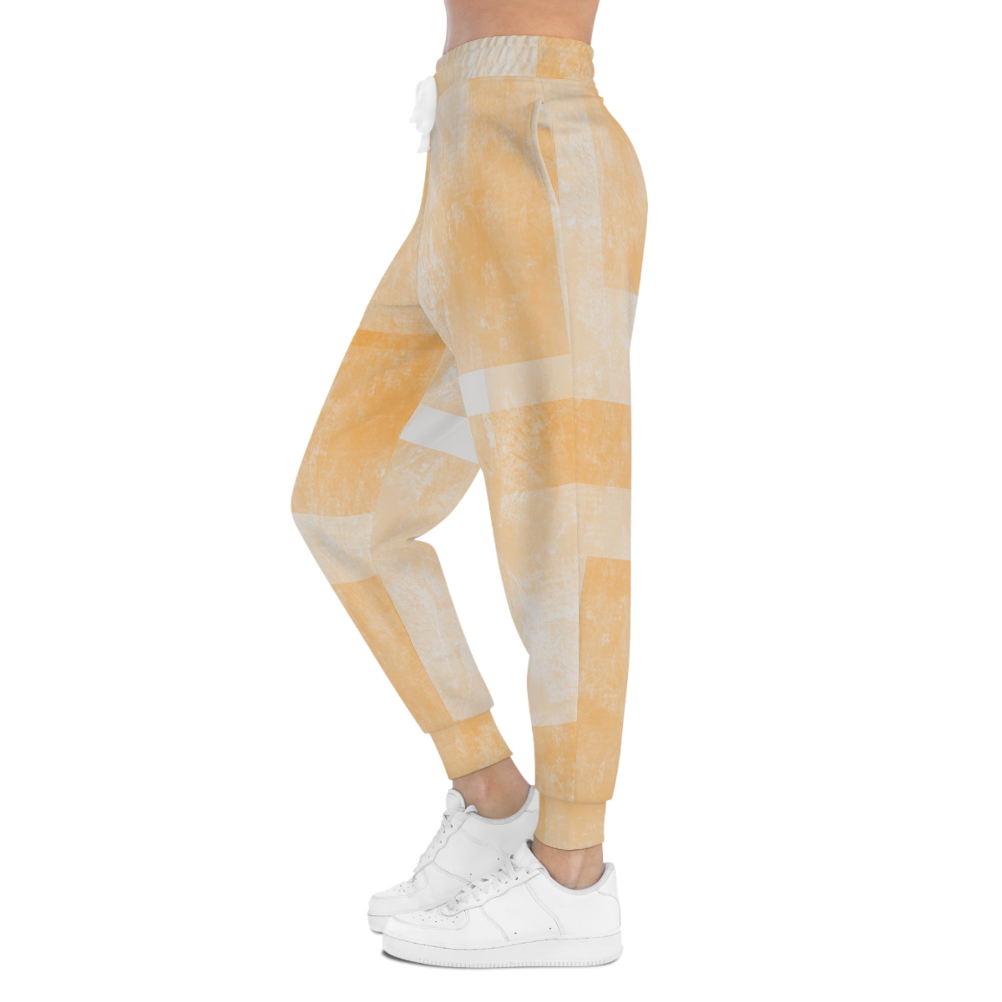Peach tie-dye joggers shown from the side with white drawstring and cuffed ankles