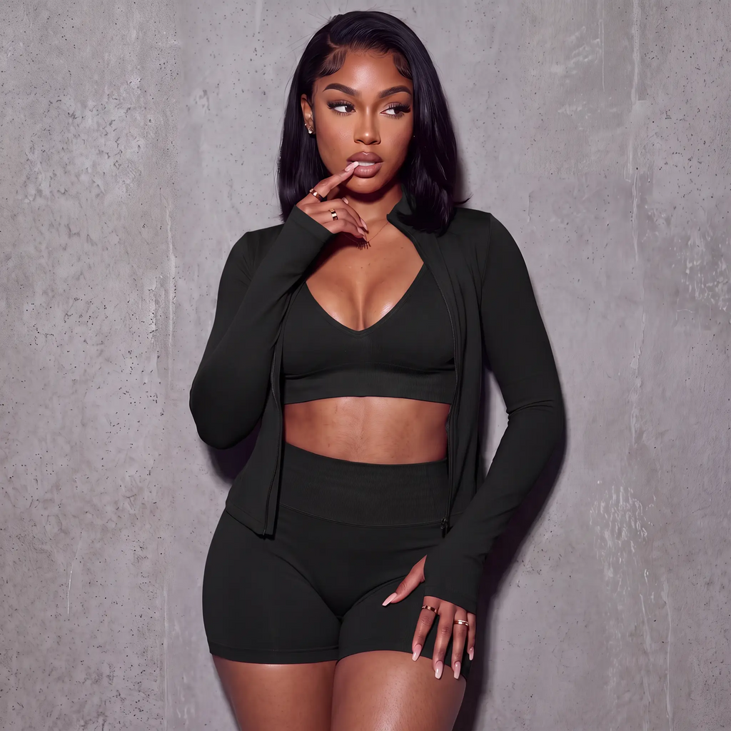 Women’s black 3-piece active set: V-neck sports bra, bike shorts, zip jacket with thumb holes.