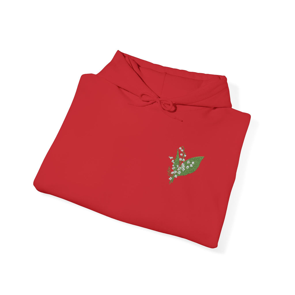 Folded red hoodie with small green leaf embroidery on chest