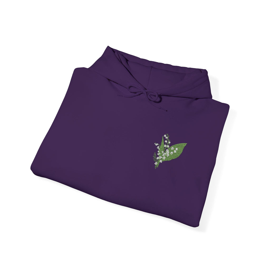 Purple hoodie folded flat with green leaf chest embroidery and drawstring hood