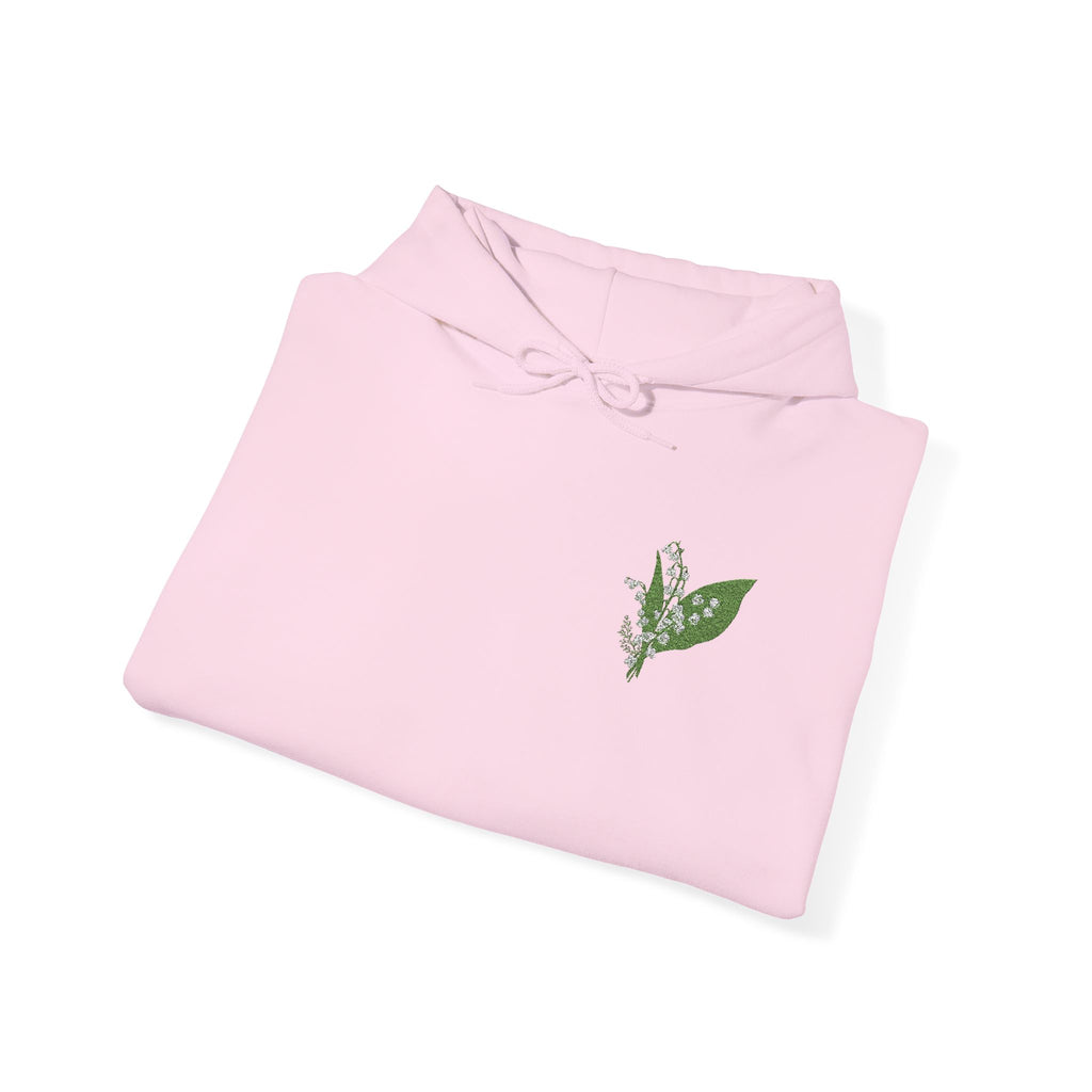 Light pink hoodie folded flat with green leaf chest embroidery and drawstring hood