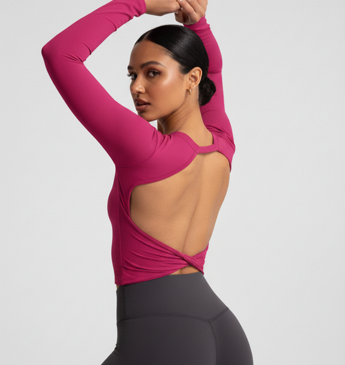 Bright pink long-sleeve fitted active crop top, open back with crisscross detail