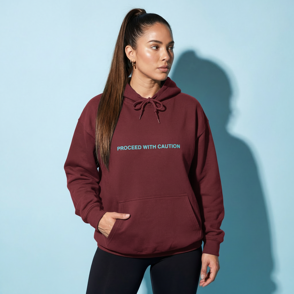 Graphic fleece hoodie, burgundy front with “Proceed With Caution” text and drawstring hood