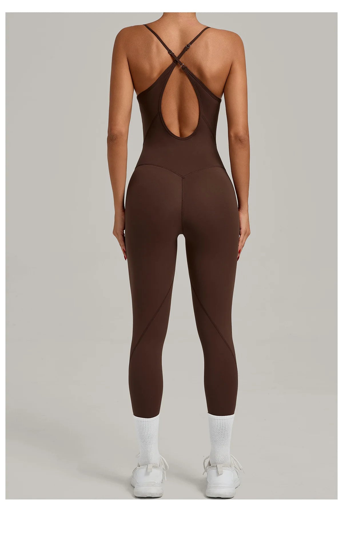 Brown yoga jumpsuit with crisscross back straps and oval mid-back cutout