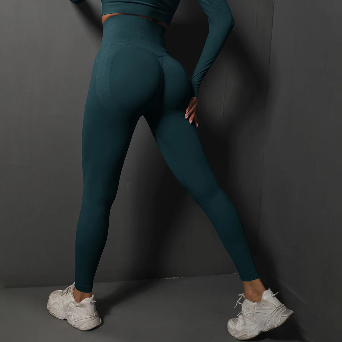 High-waist yoga leggings, dark teal, back view with curved seam lines