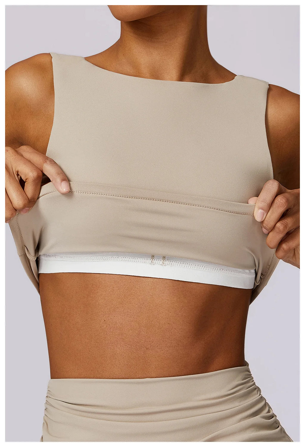 Women’s sports bra crop top in light tan, sleeveless with straight neckline and hem seam