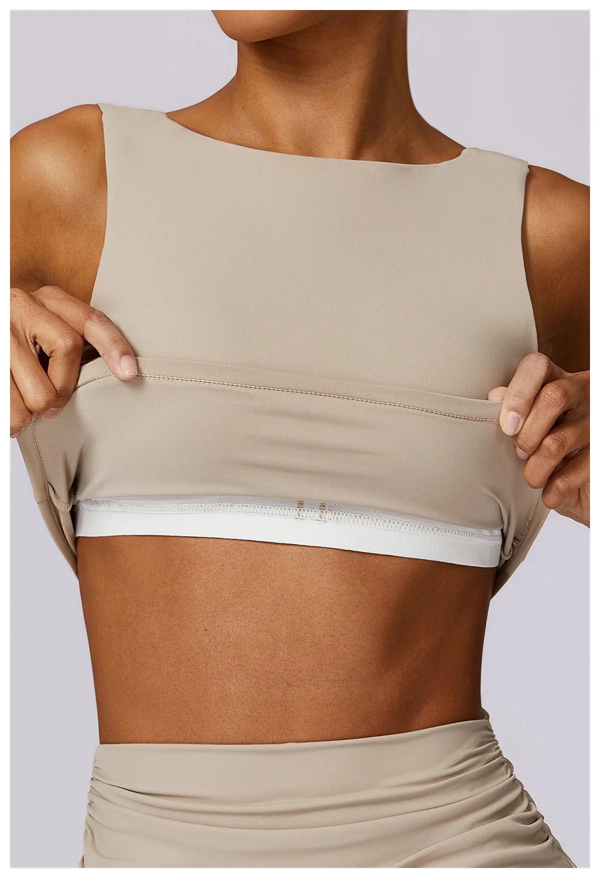 Women’s sports bra crop top in light tan, sleeveless with straight neckline and hem seam