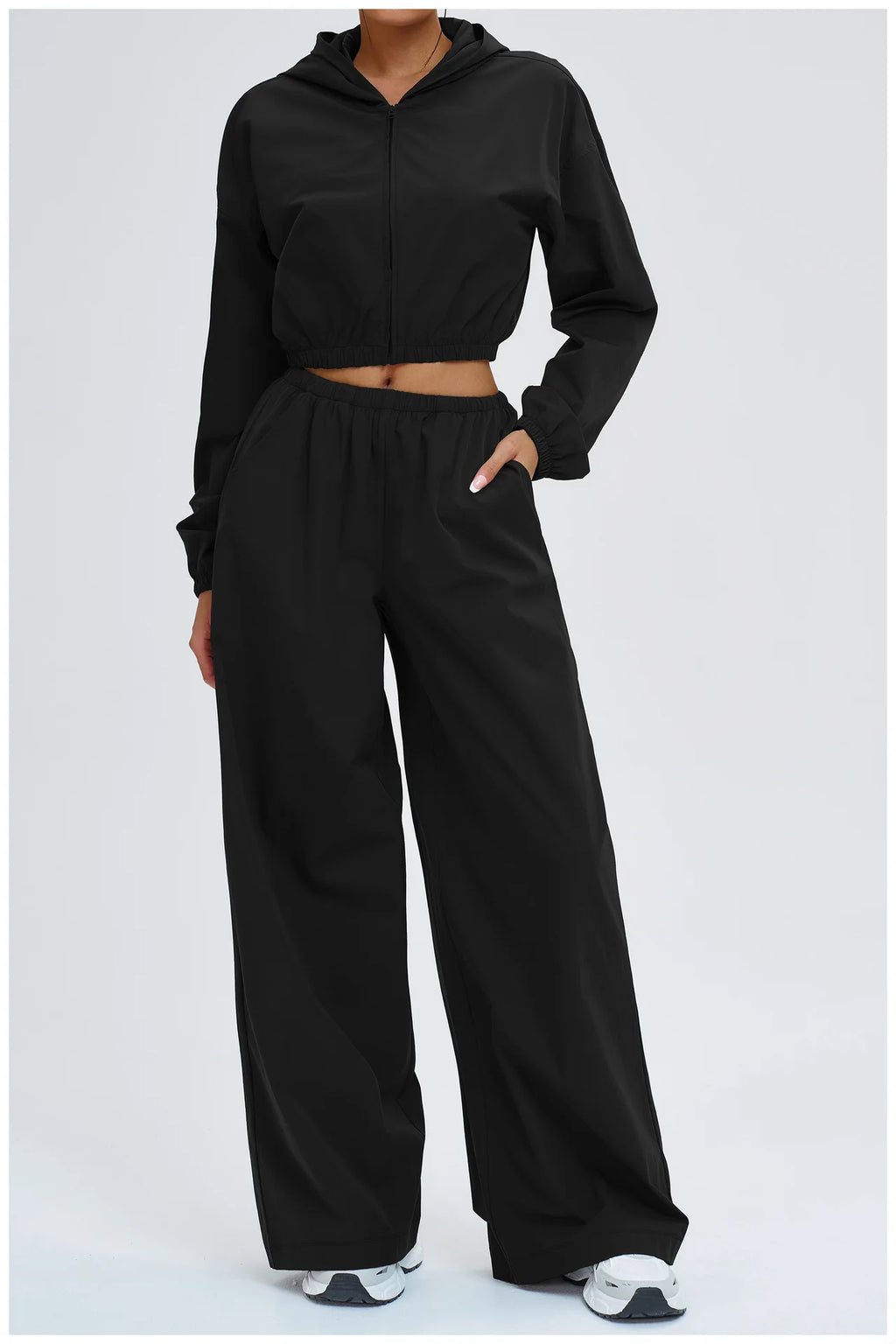 Women’s black high-rise wide-leg pants with elastic waistband and straight drape.