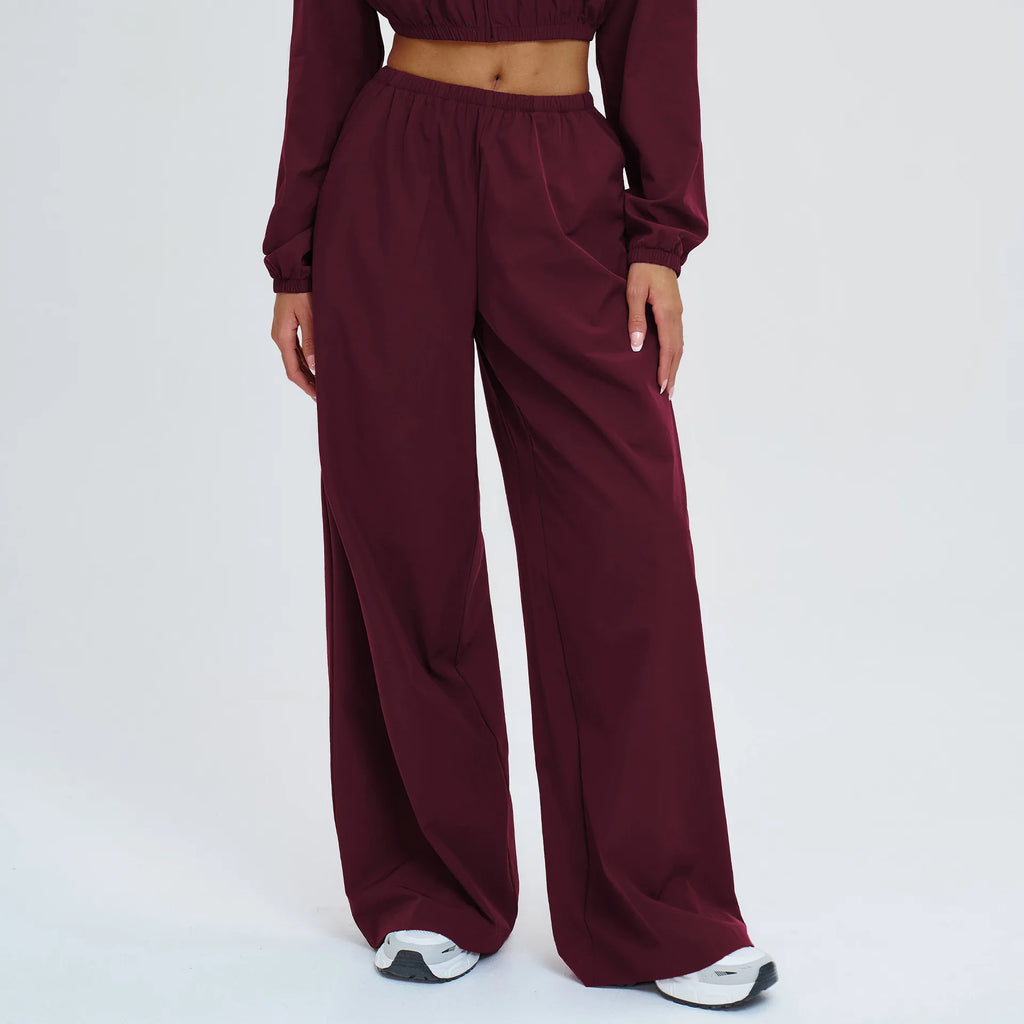 Women's burgundy wide-leg sports pants with elastic waistband