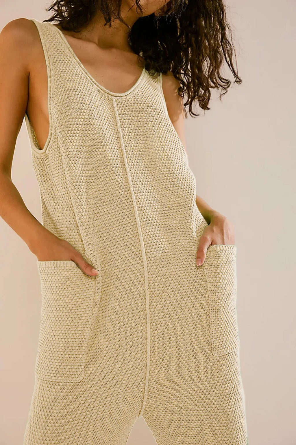 Light ivory knit wide-leg romper with scoop neck and front pockets
