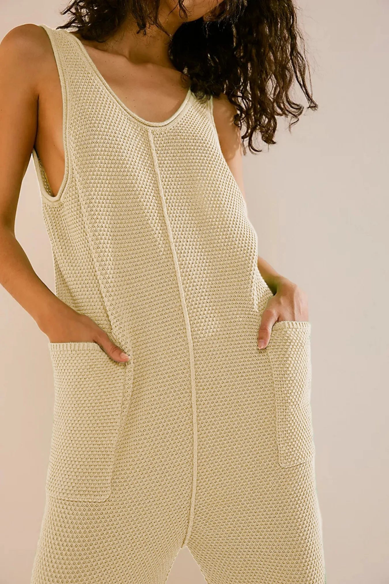 Light ivory knit wide-leg romper with scoop neck and front pockets