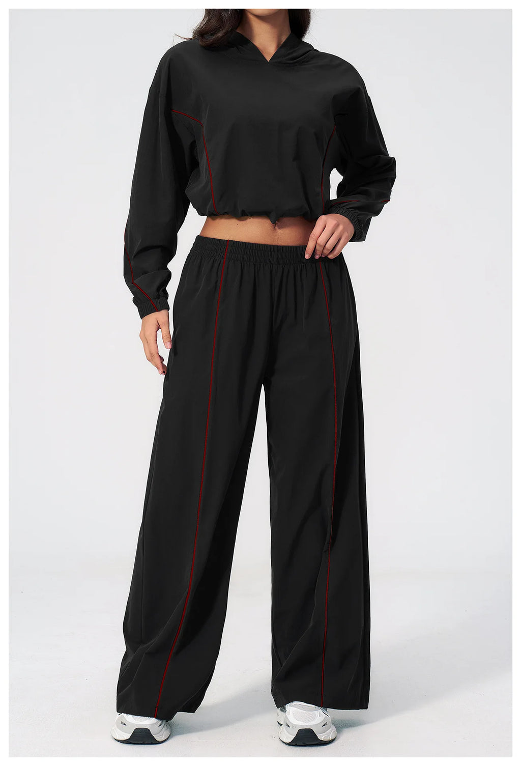 Women’s black hooded windbreaker and wide-leg pants set with red piping details