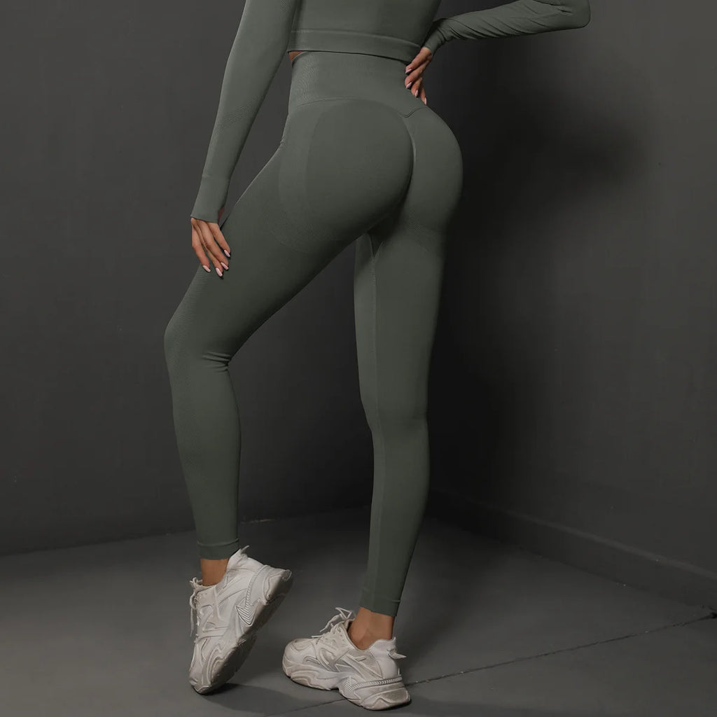 High-waist green yoga leggings with contour panels and fitted ankle-length design.