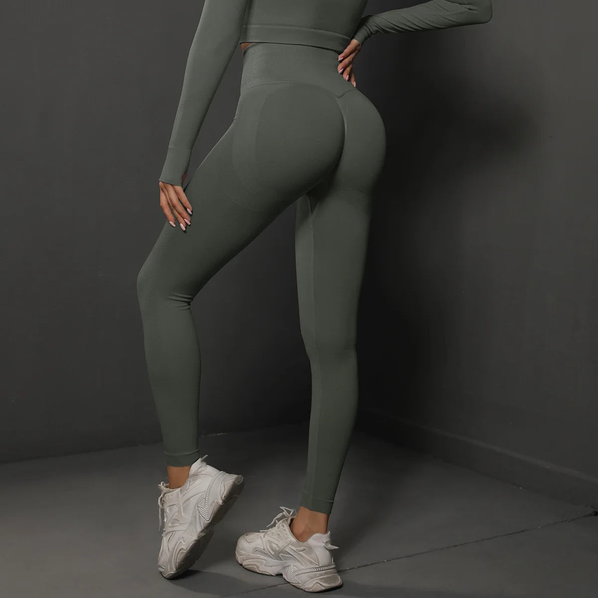 High-waist green yoga leggings with contour panels and fitted ankle-length design.