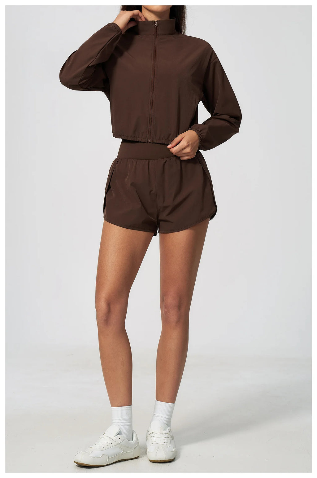 Brown zip-up long-sleeve sports jacket with elastic waistband and matching shorts