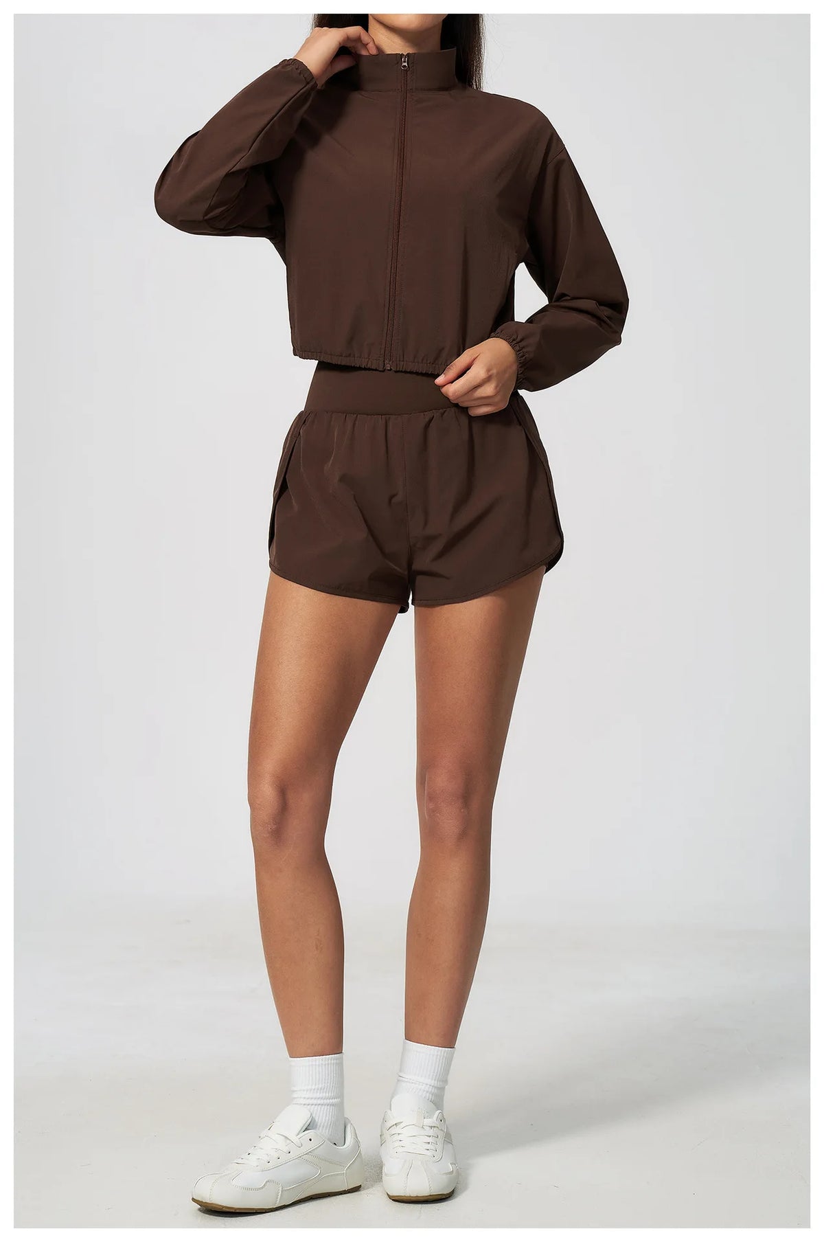 Brown zip-up long-sleeve sports jacket with elastic waistband and matching shorts