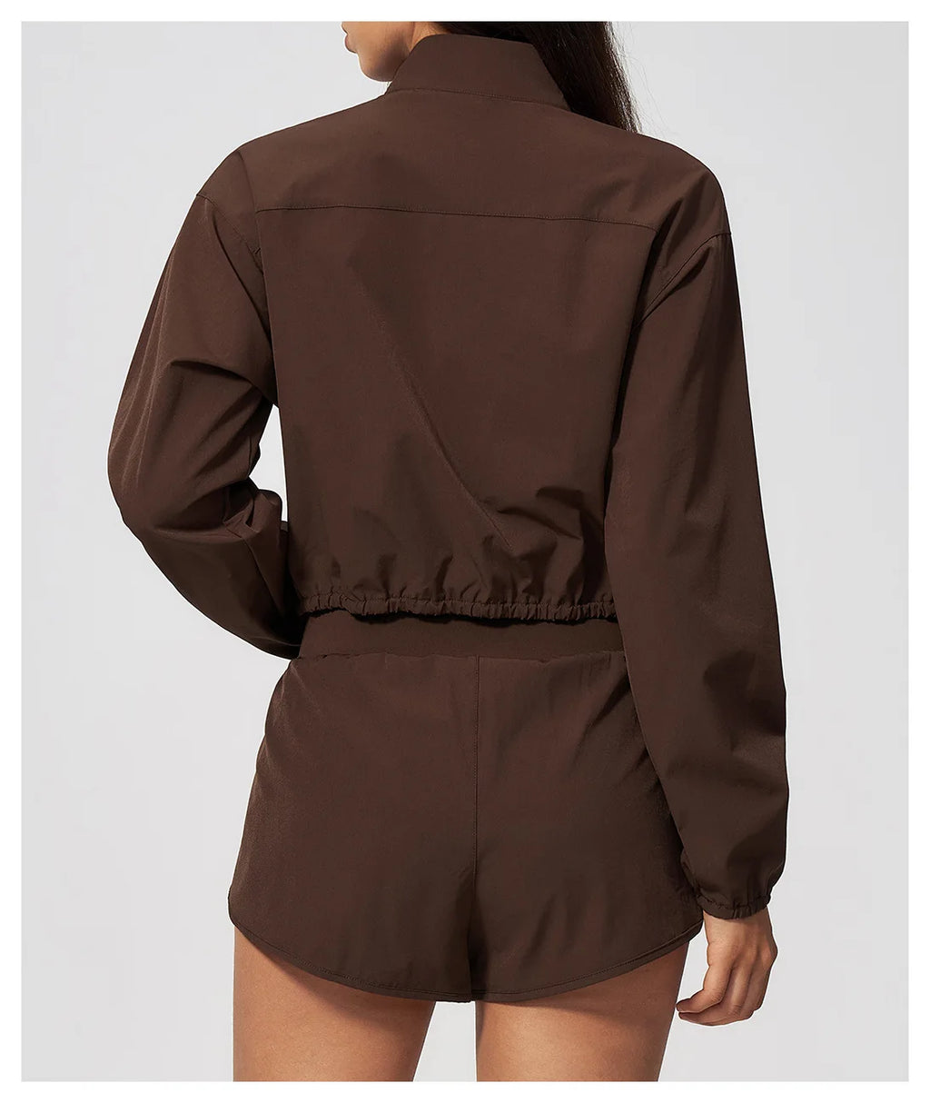 Brown zip-up sports jacket with long sleeves and elastic hem, back view