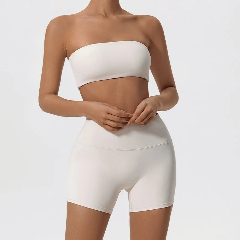 Two-piece fitness set with white strapless bandeau bra and matching biker shorts