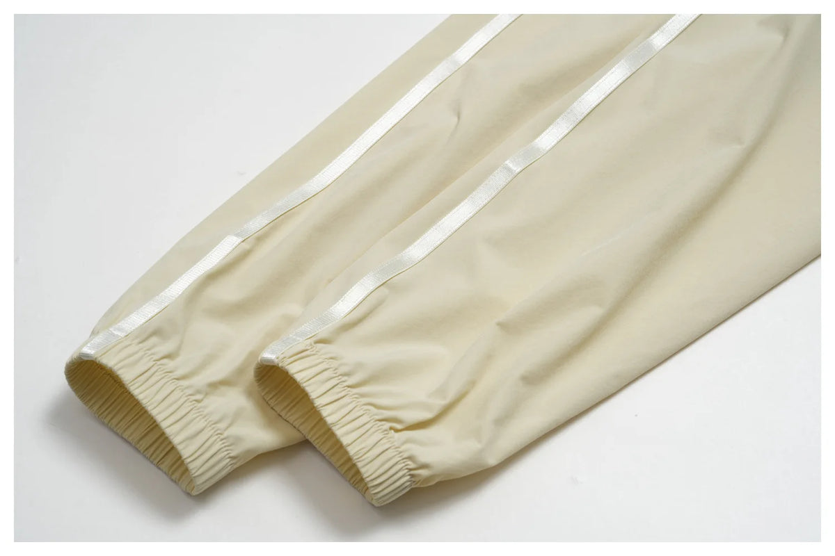 Women’s zip-up athletic jacket, light cream with elastic cuffs and side seams