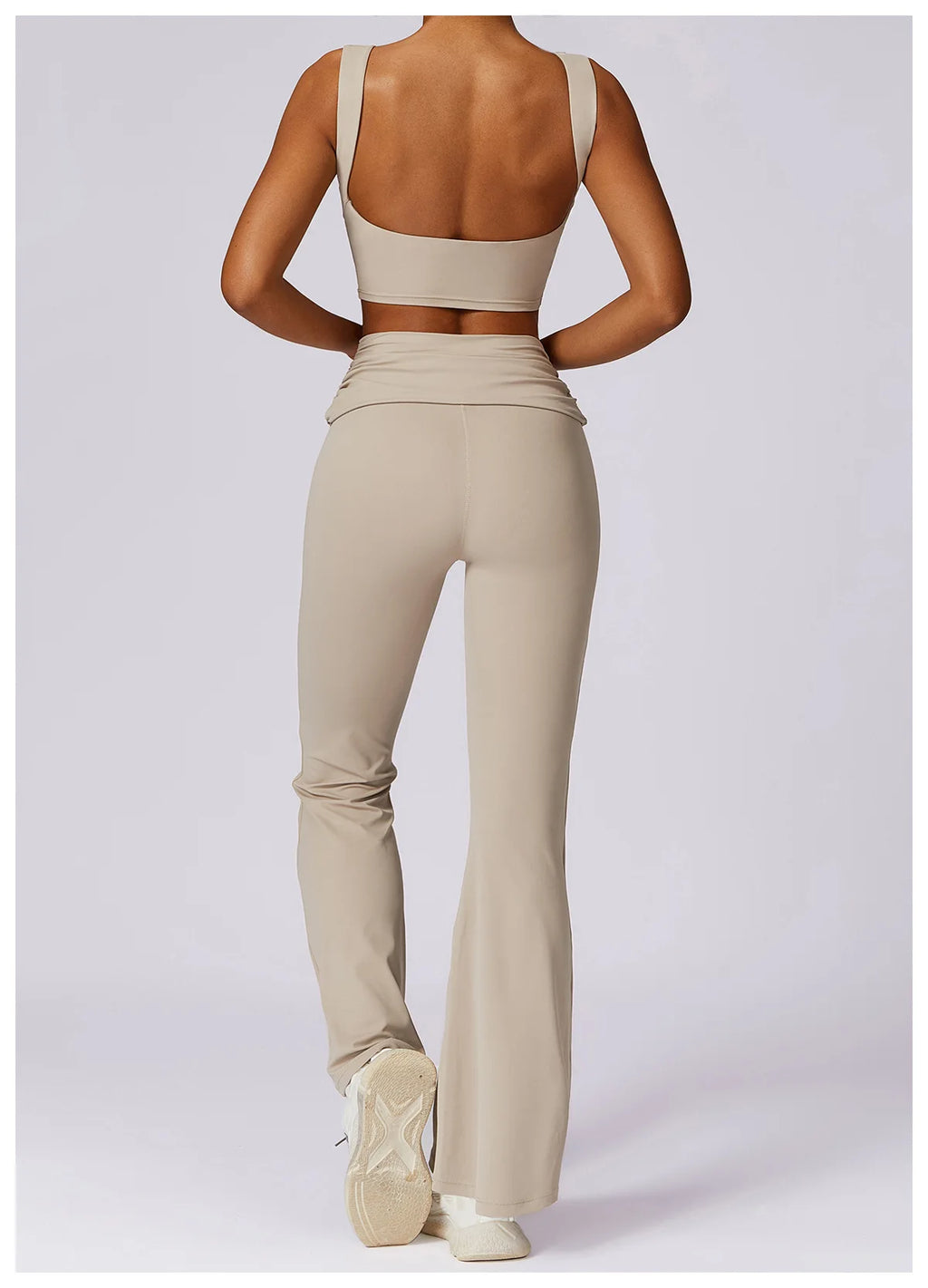Beige backless sports bra crop top with wide open back and matching fit.