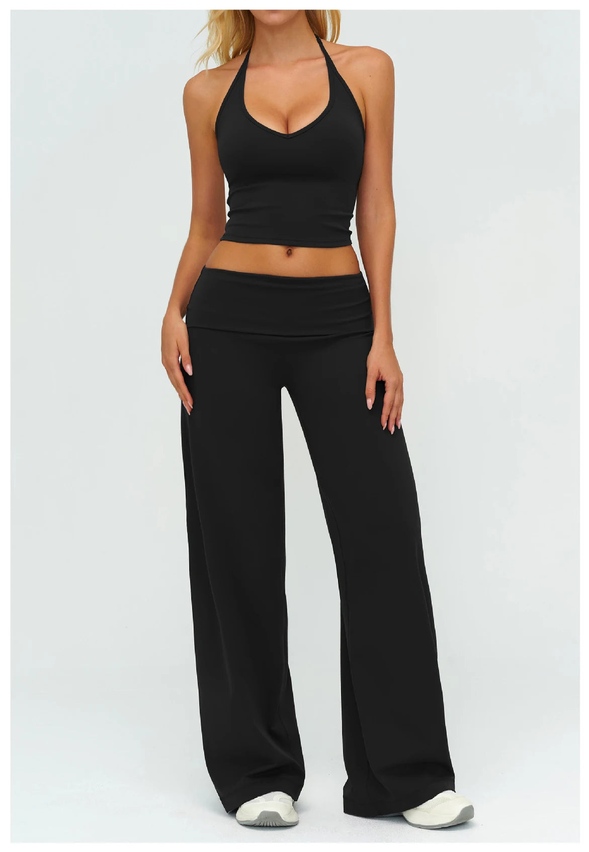 Black yoga set: halter sports bra and wide-leg pants, sleeveless midriff cut