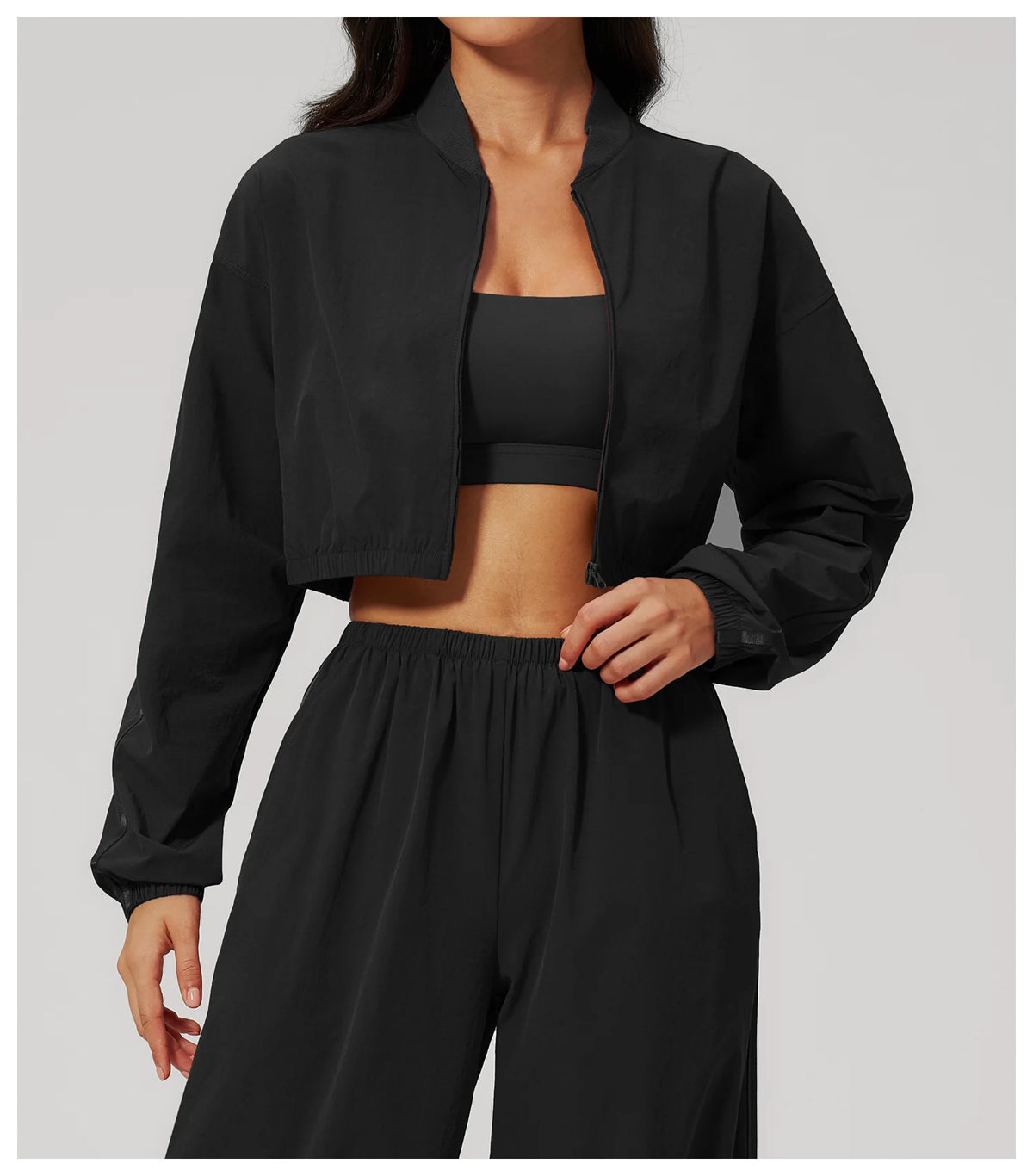 Women’s cropped yoga jacket in black with stand collar and zip front
