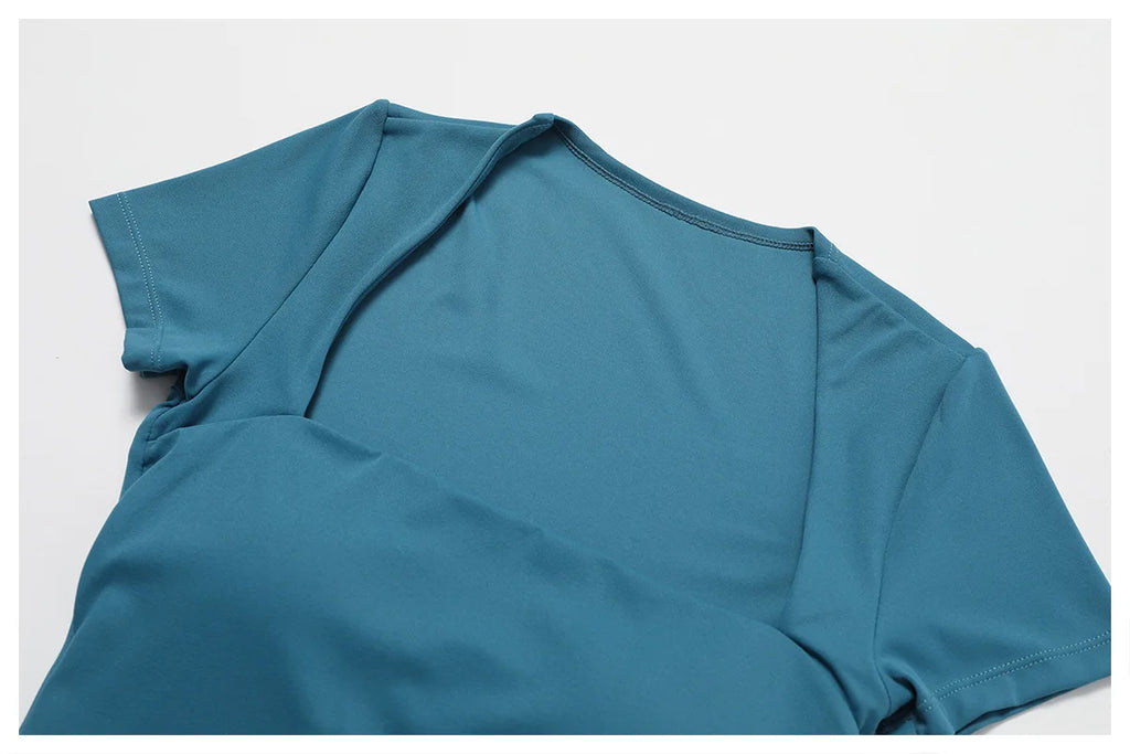 Women's peacock blue short-sleeve yoga bodysuit, folded sleeve and neckline