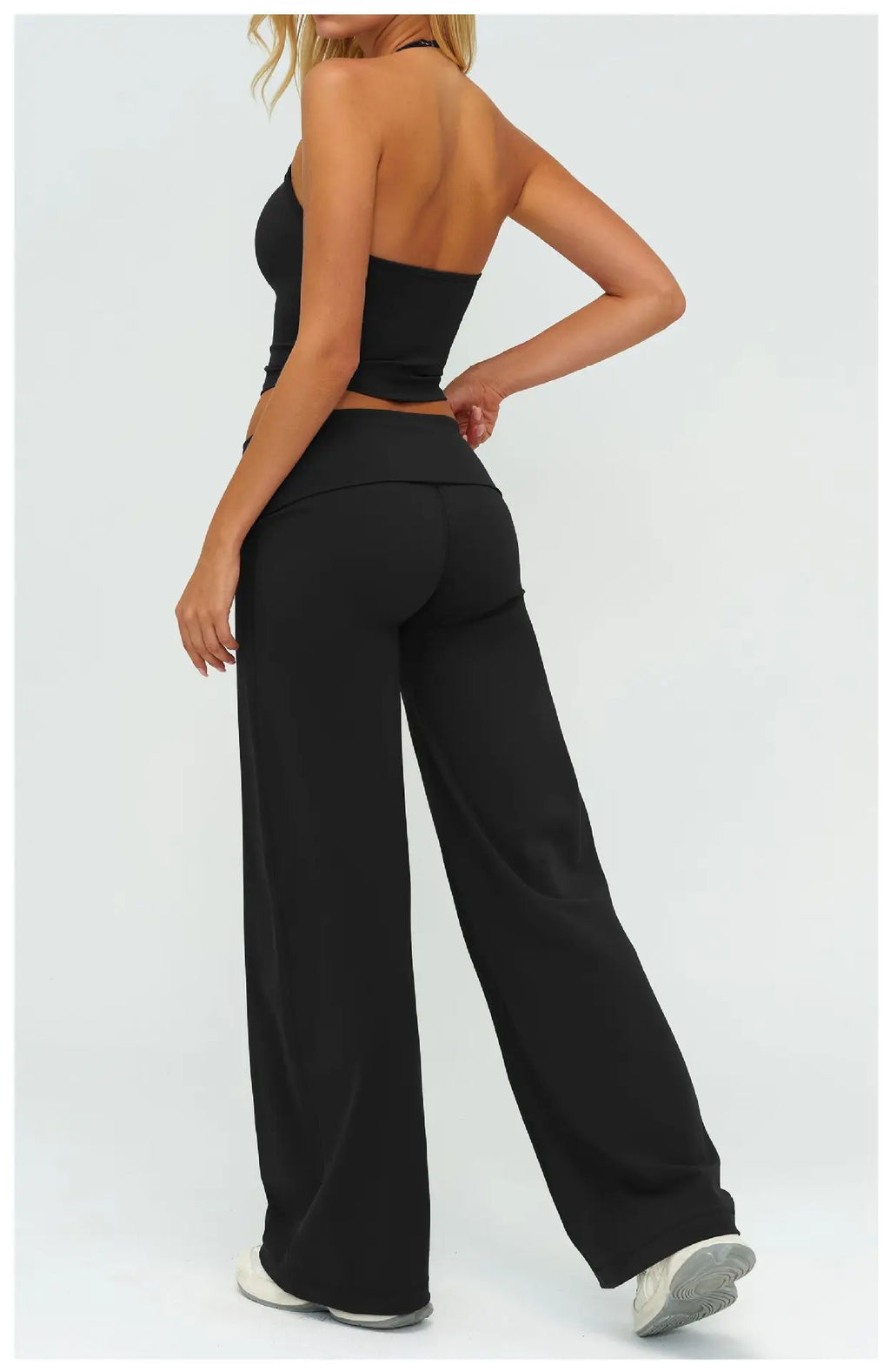 Black wide-leg yoga pants with high-rise waistband, paired with sports bra