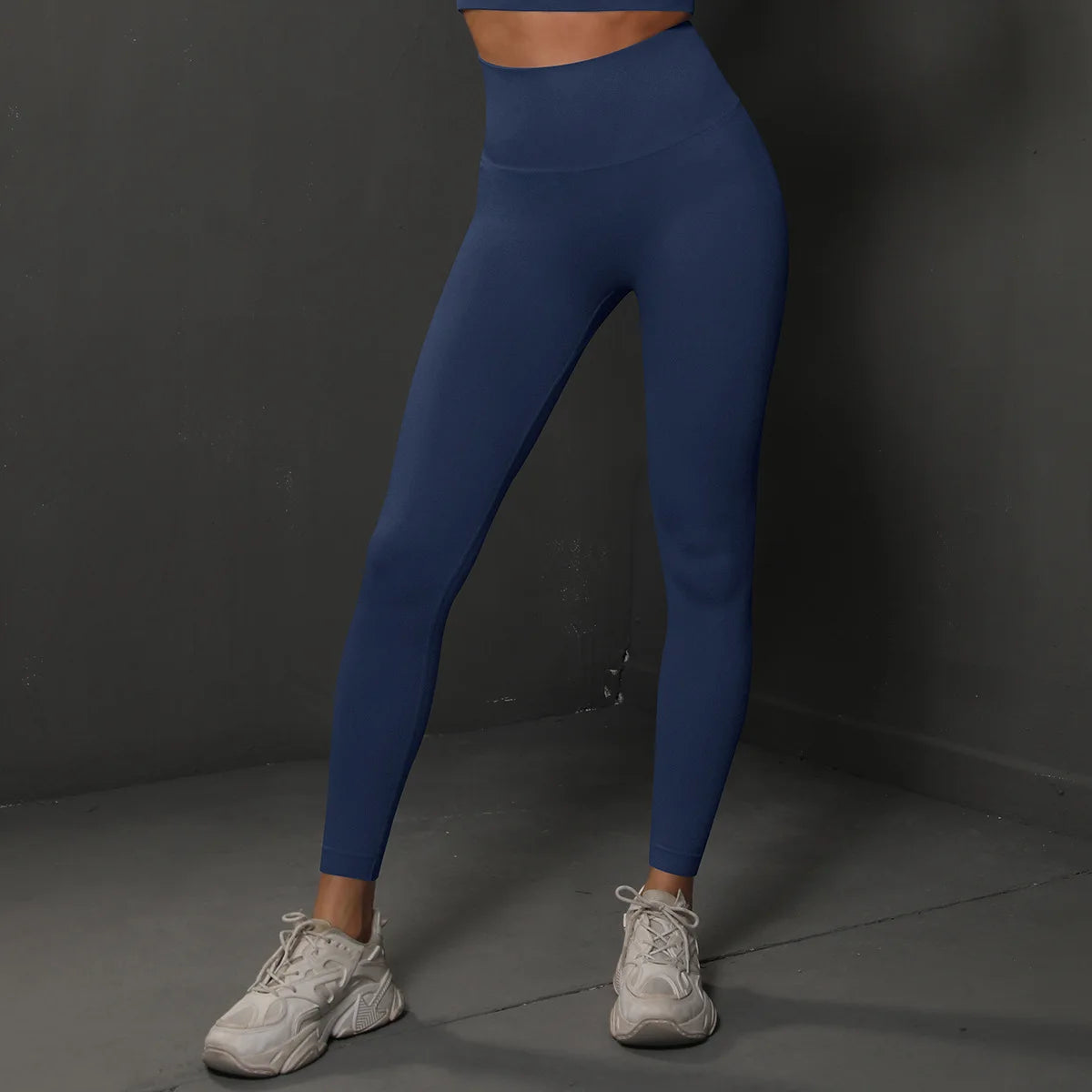 High-waist blue yoga leggings with smooth stretch fabric and tapered ankle length.