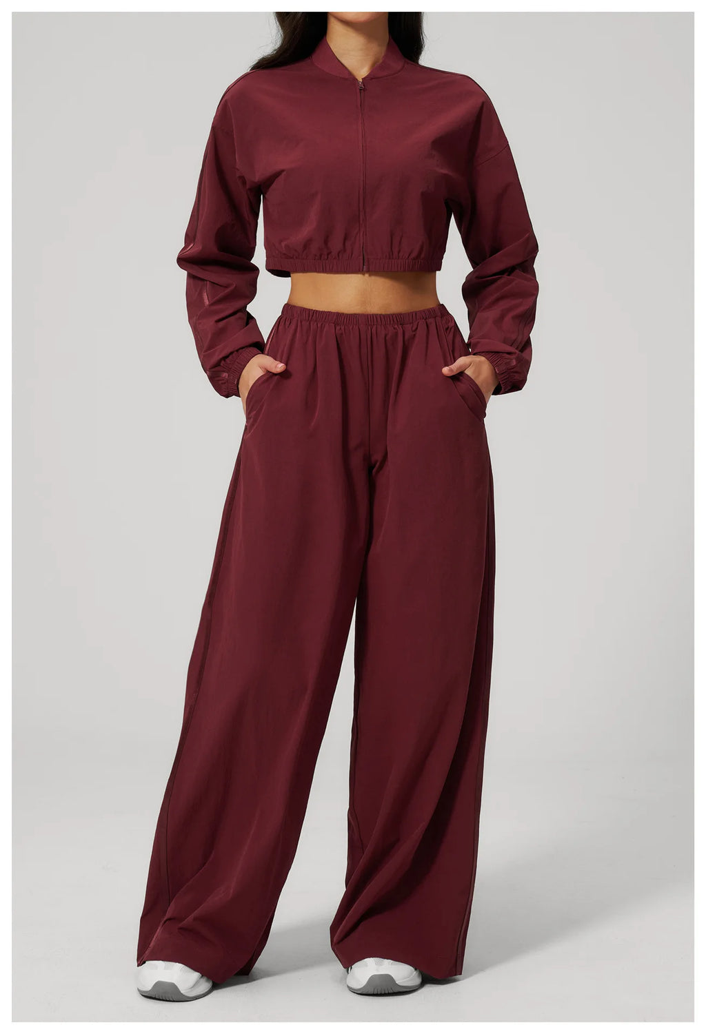 Women’s cropped yoga jacket in deep maroon with front zipper and elastic cuffs