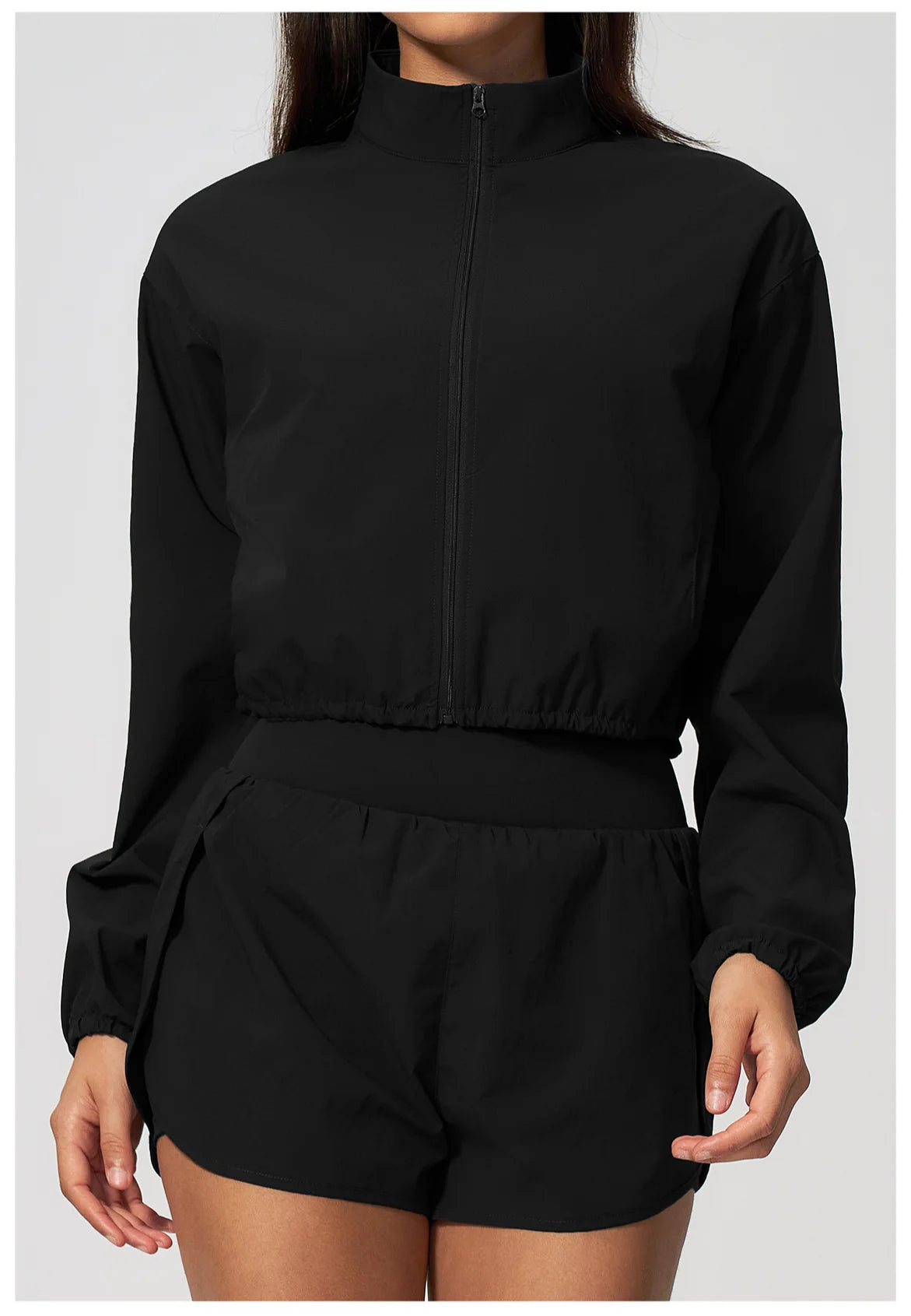 Black zip-up long sleeve sports jacket with full front zipper and elastic waist