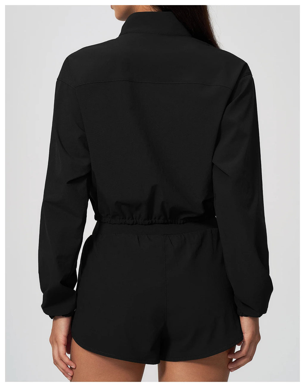 Black zip-up long sleeve workout jacket from back with elastic waistband