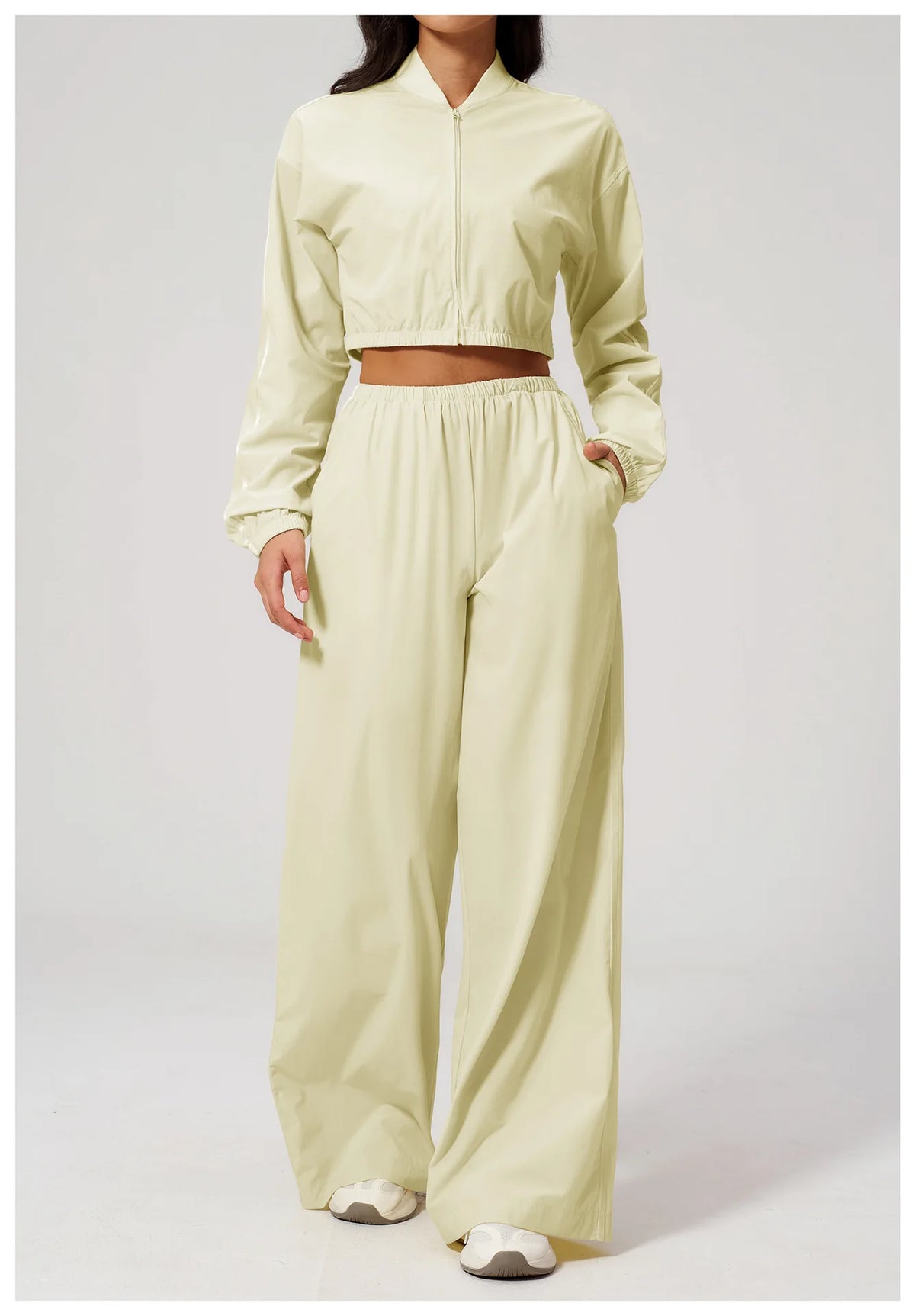 Women’s almond yellow cropped zip-up jacket with long sleeves and elastic cuffs.