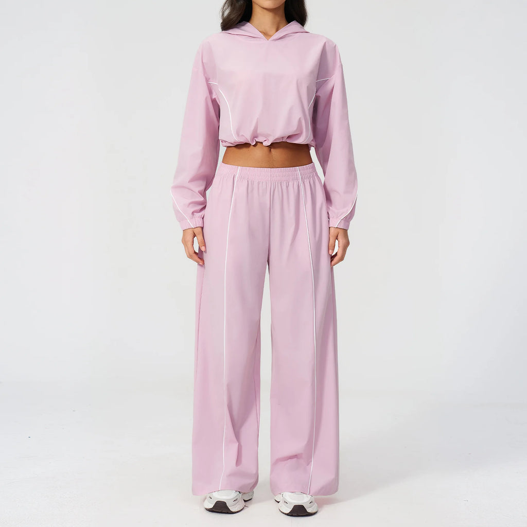 Light pink hooded windbreaker pullover with matching wide-leg pants set