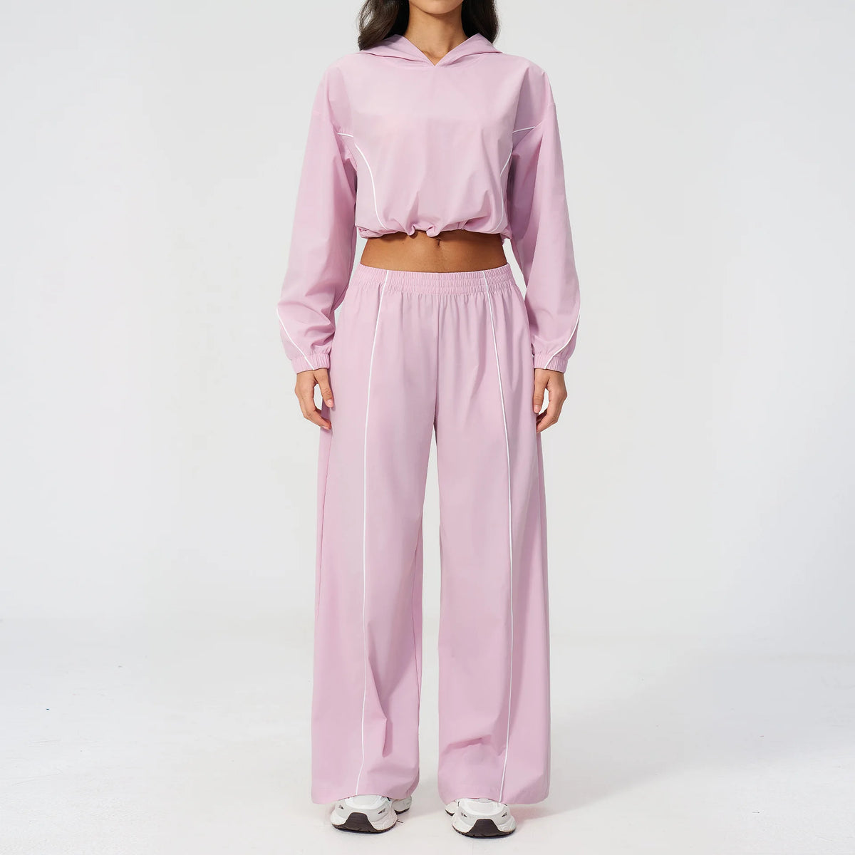 Light pink hooded windbreaker pullover with matching wide-leg pants set