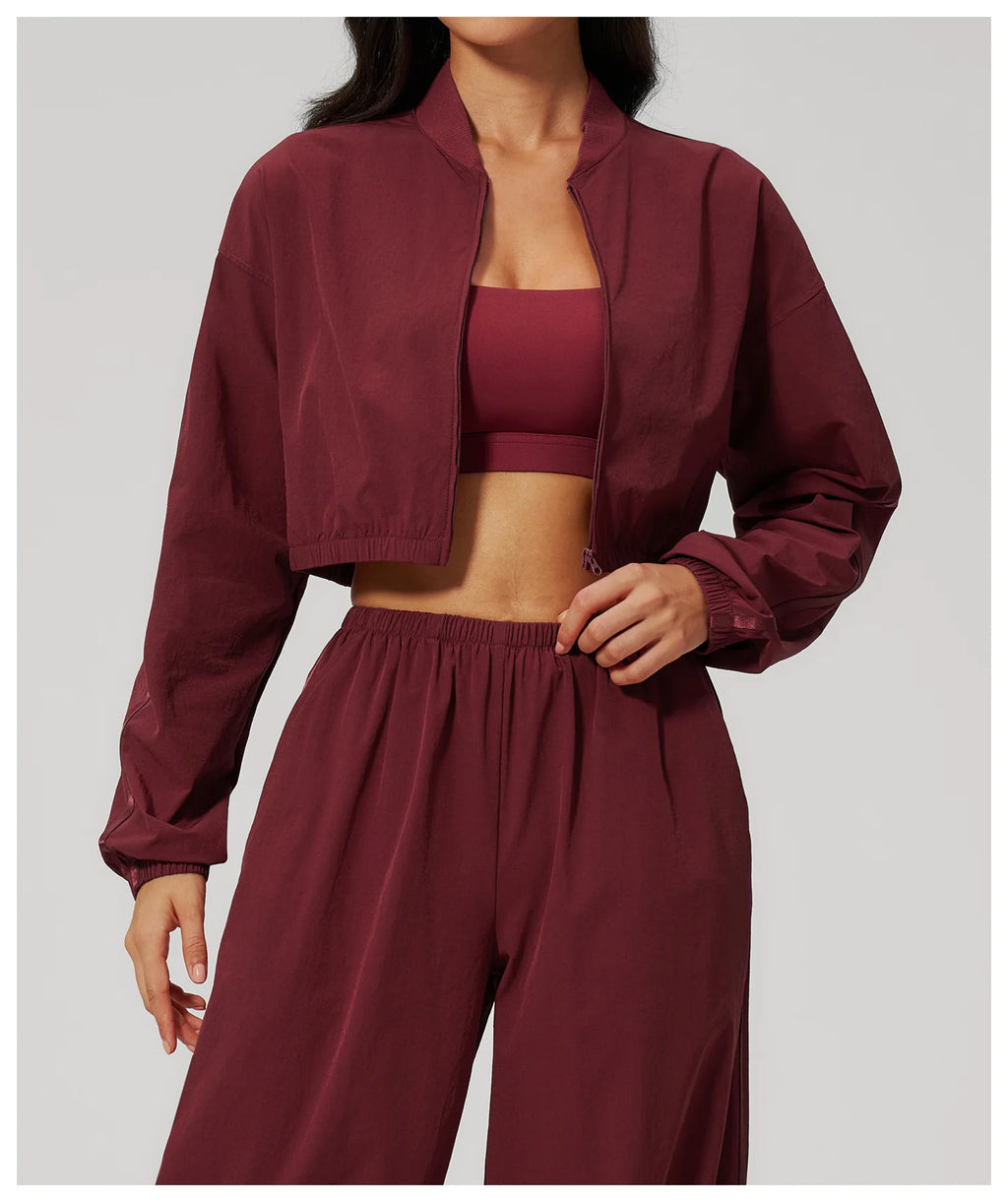 Women’s cropped yoga jacket in deep maroon with stand collar and zip front
