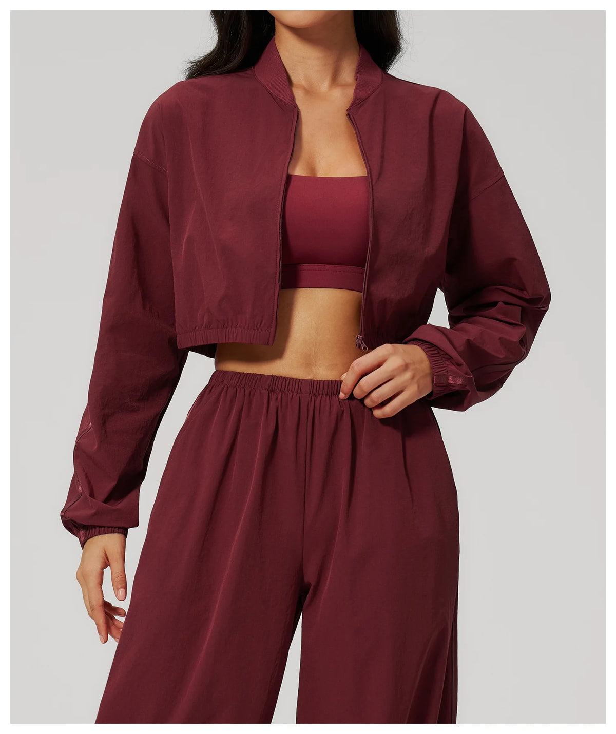 Women’s cropped yoga jacket in deep maroon with stand collar and zip front