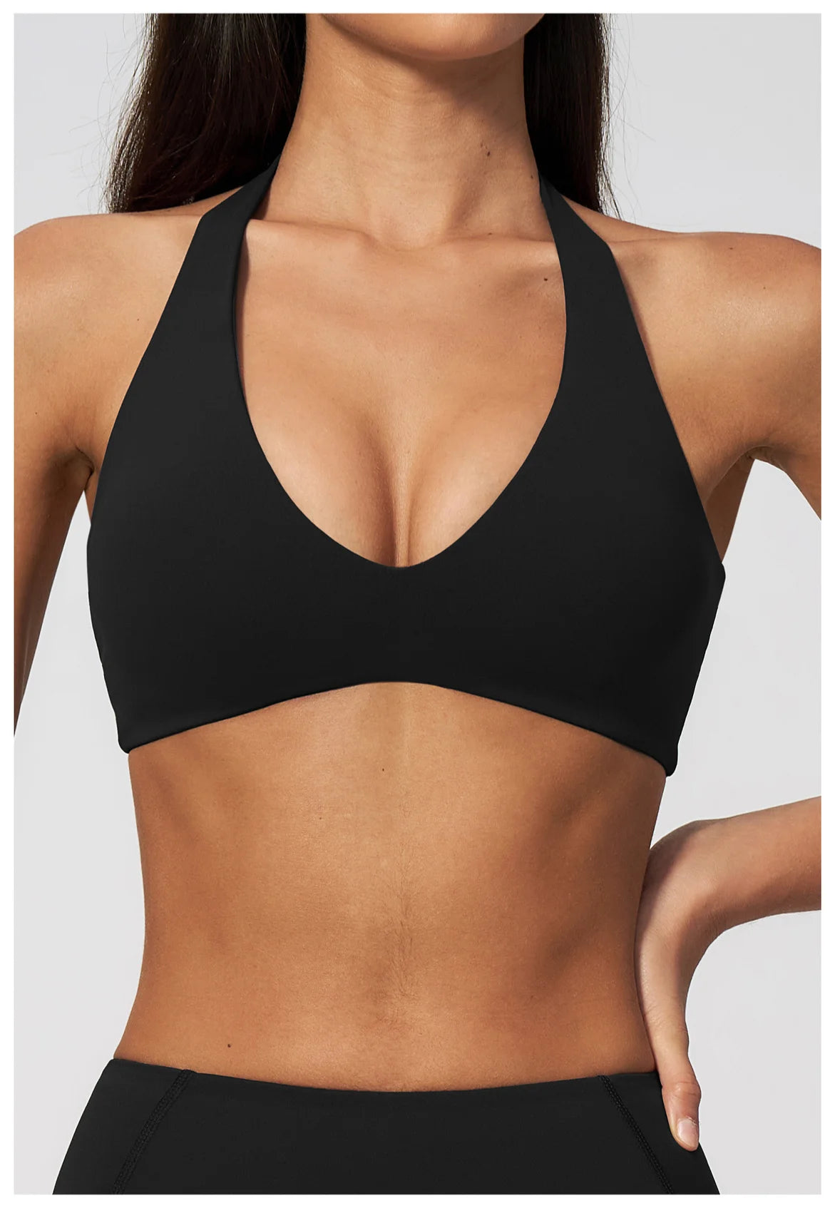 Black halter neck yoga sports bra with deep V neckline, cropped workout top