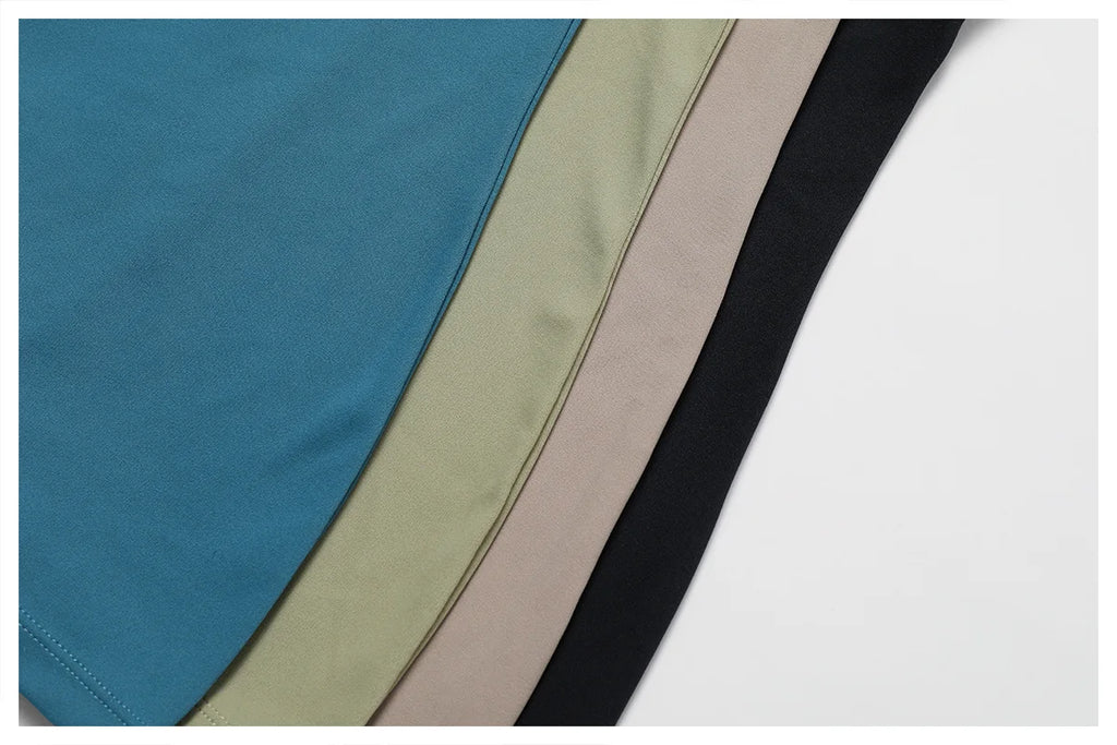 Women's yoga bodysuit color options—blue, green, beige, and black panels