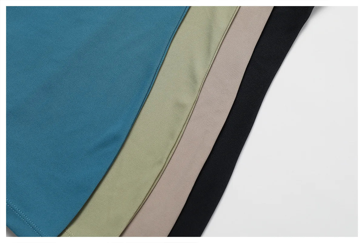 Women's yoga bodysuit color options—blue, green, beige, and black panels