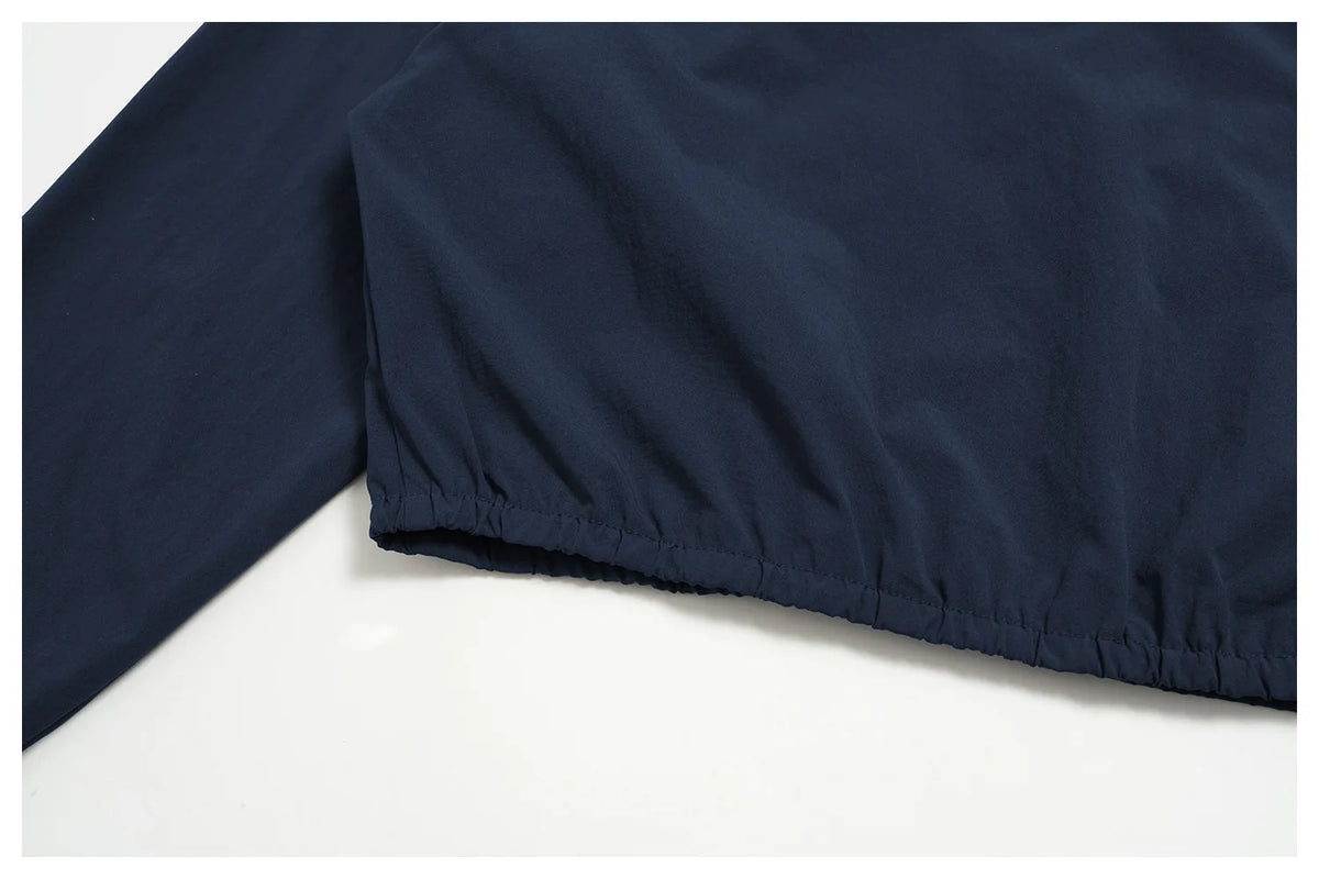 Indigo blue zip jacket with gathered elastic hem and smooth fabric finish