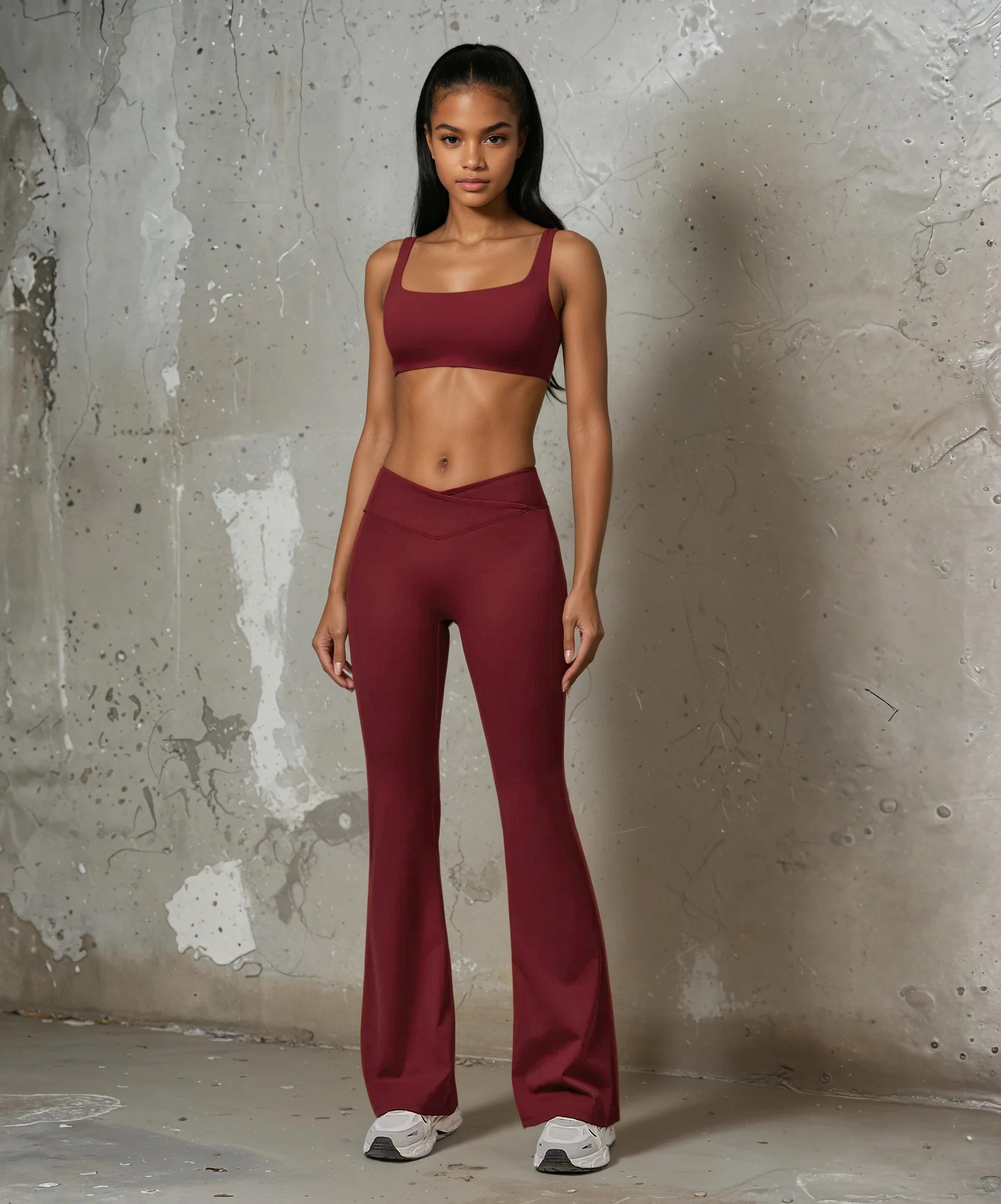 Stylish Xooie Fit flare pants and bra workout outfit in burgundy for comfortable exercise