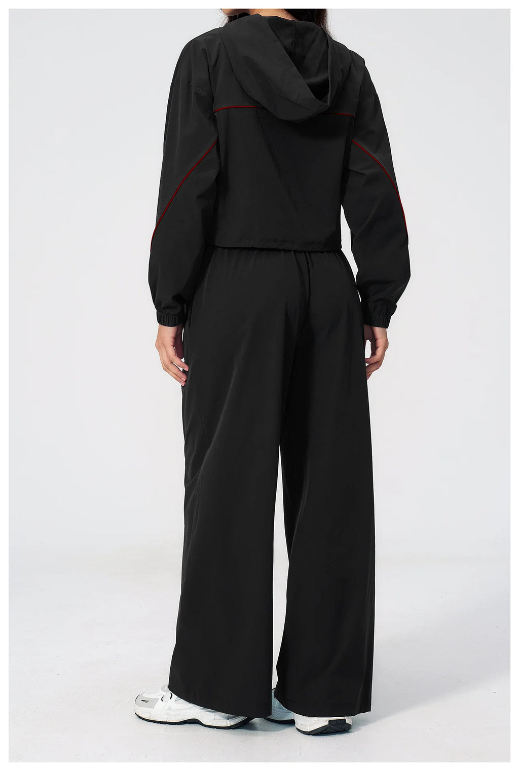 Women’s black hooded windbreaker and wide-leg pants set with red seam accents