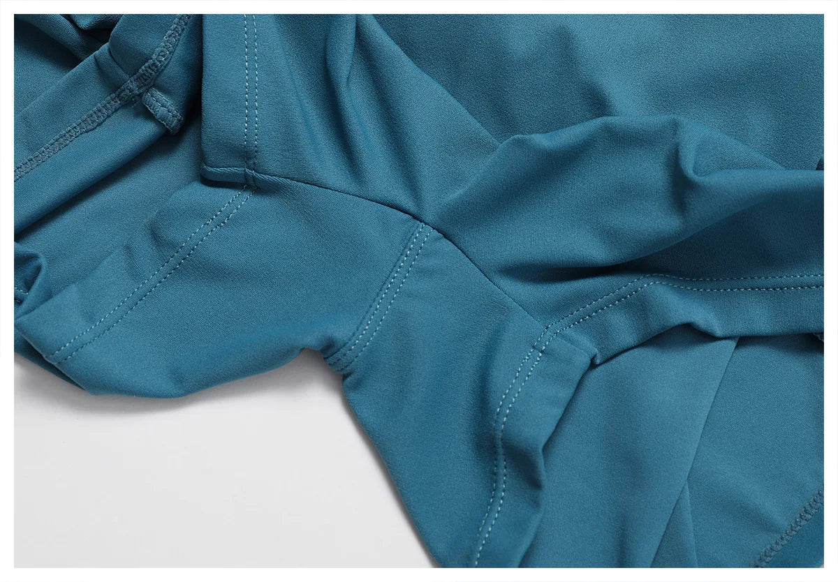Women's peacock blue yoga bodysuit close-up of seams and fabric texture