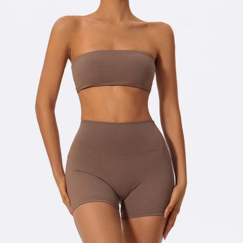 Two-piece fitness set with taupe strapless bandeau bra and matching biker shorts