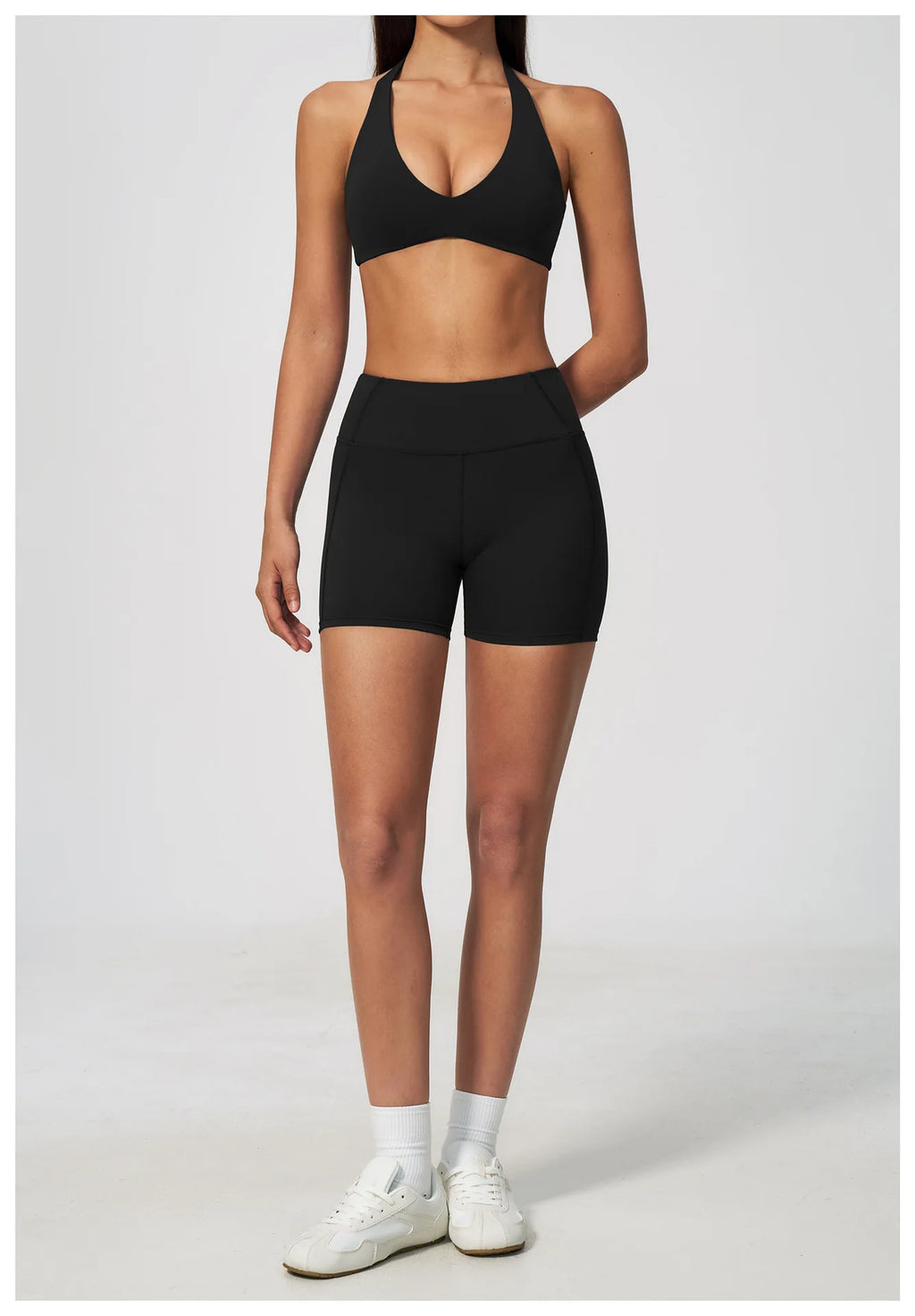 Black halter yoga sports bra with V plunge front and matching high-waist shorts look