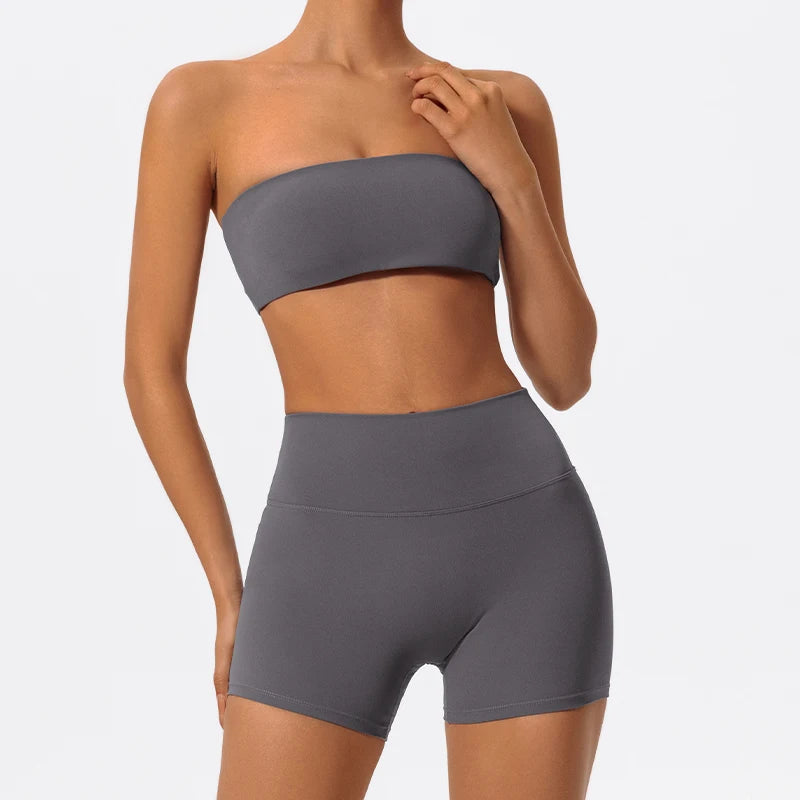 Two-piece fitness set with charcoal strapless bandeau bra and matching biker shorts