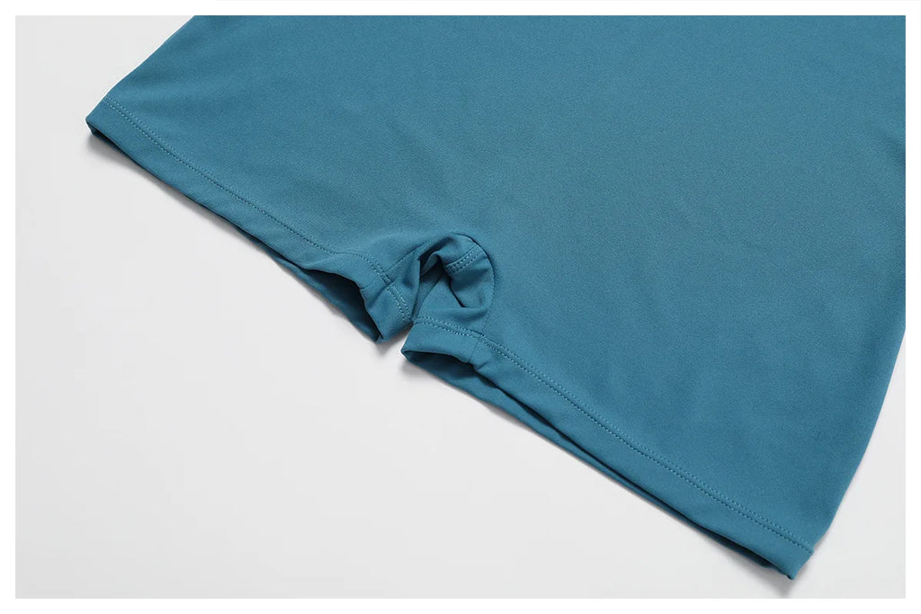 Women's peacock blue yoga bodysuit leg hem with gathered seam